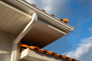Seamless gutters and downspout on a home with a tile roof.
