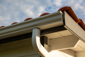 Seamless gutters on a house with a tile roof.